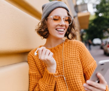 Smiling Girl With Phone and Earphones